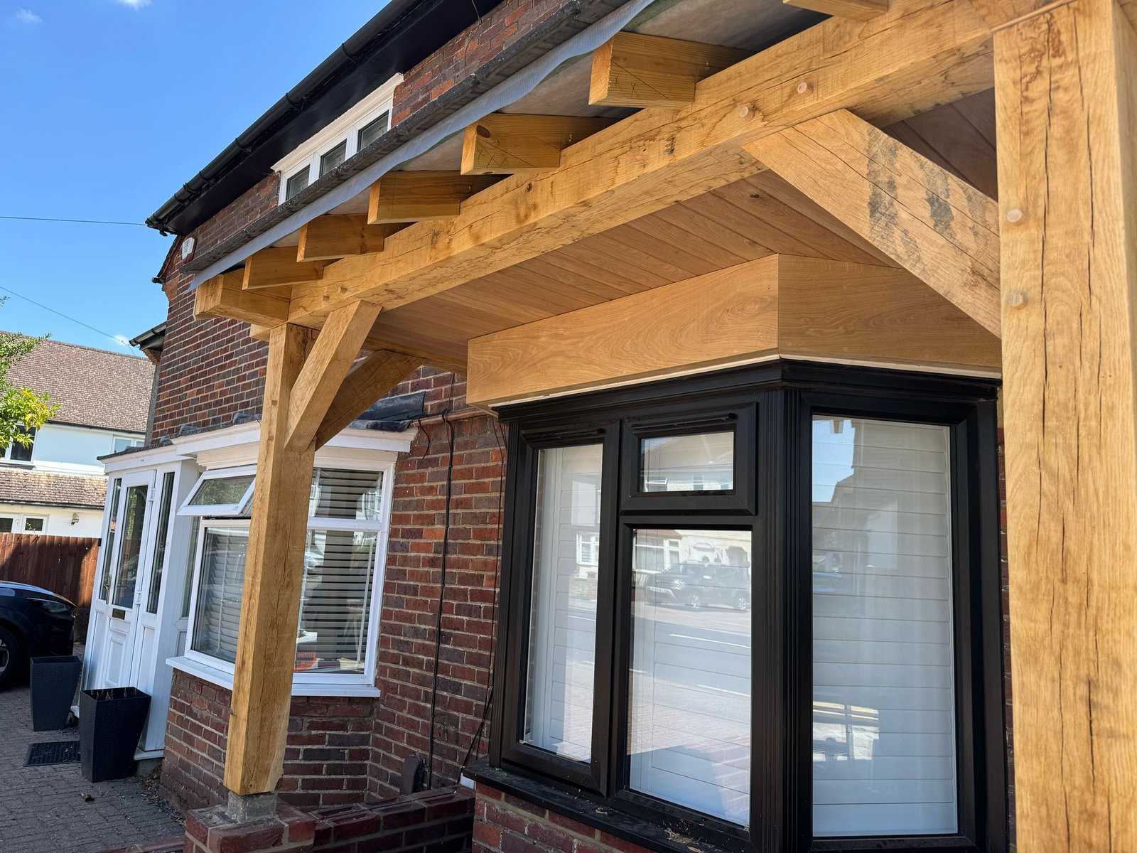 Complete oak porch extension with black framed bay windows