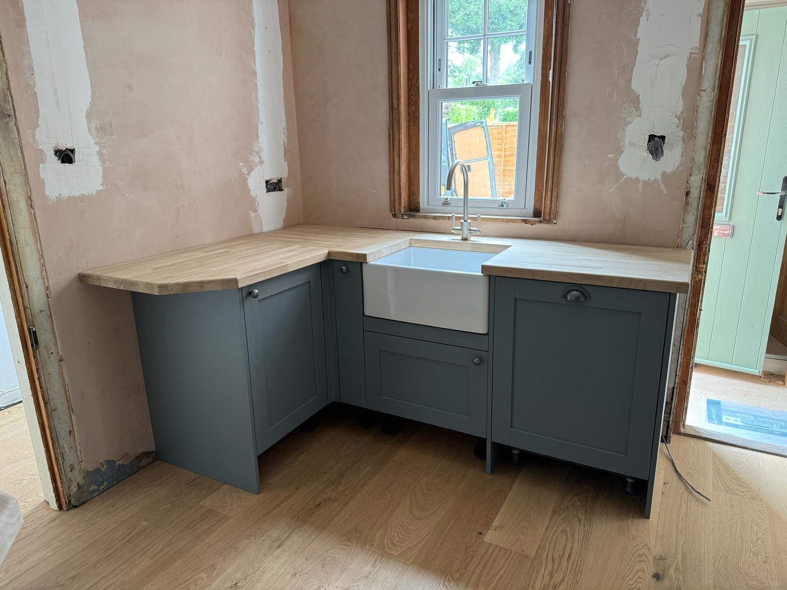 Corner sink unit with windows in grey cabinets