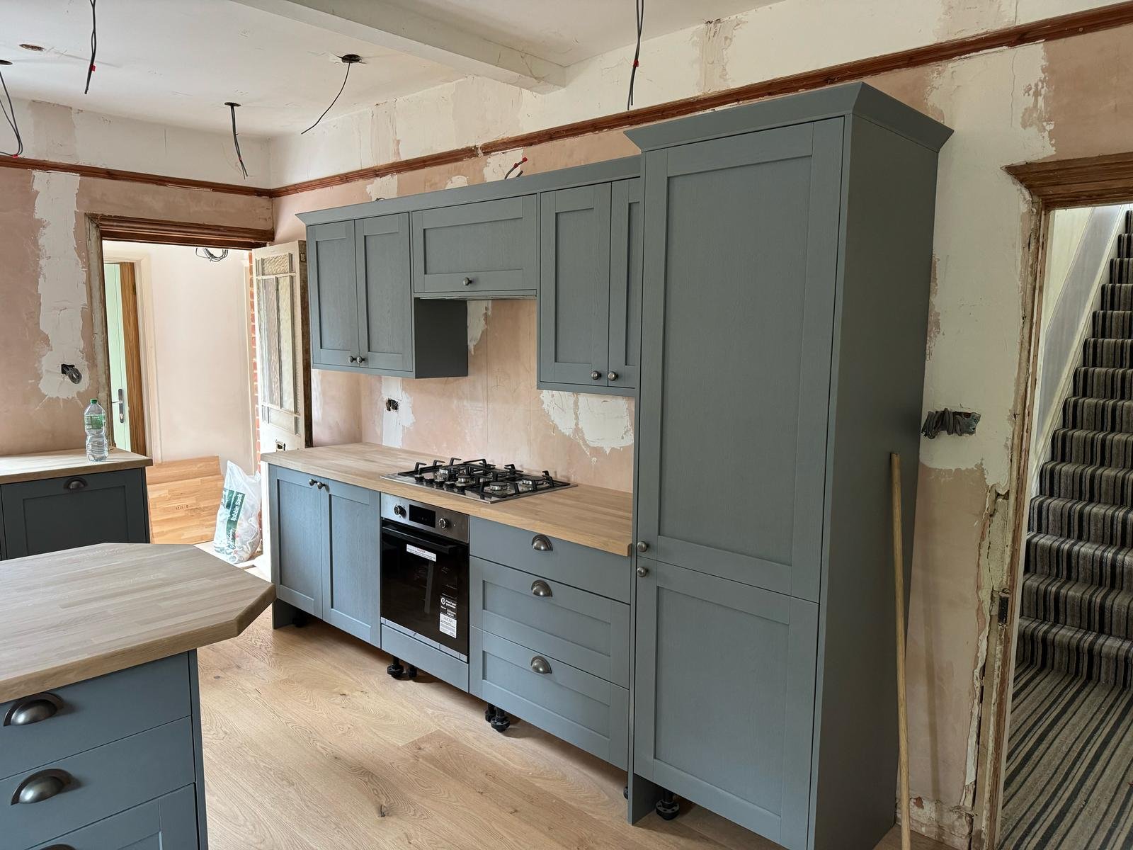 Full kitchen wall with appliances and storage units