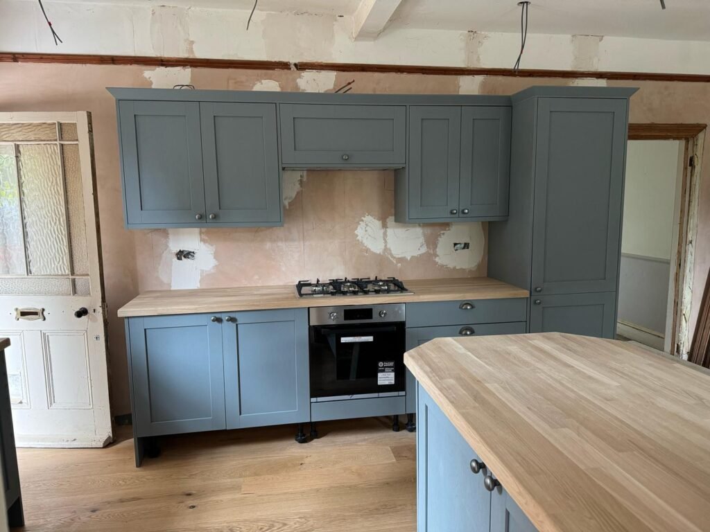 Gas hob and oven fitted in blue cabinets