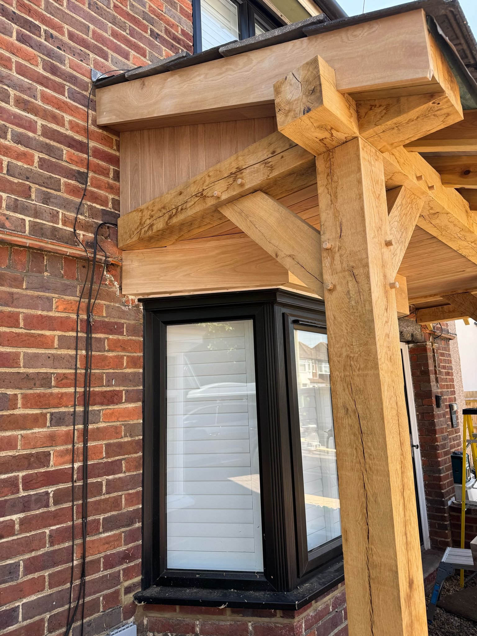 Oak frame porch corner detail with decorative joinery work